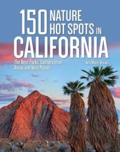 Front cover image of 150 Nature Hot Spots in California with red mountains and interesting trees