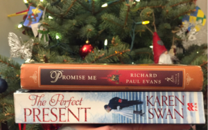 Image of two books: Karen Swan's The Perfect Present and Richard Paul Evans' Promise Me in front of a Christams Tree